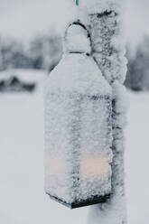 Snow-covered lantern on lamppost in winter - LHPF01541