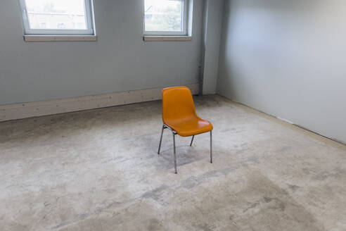 Orange color chair in empty room - JOSEF18726