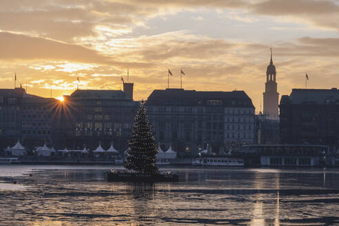 Germany, Hamburg, Christmas tree in Alster Lake at sunset - KEBF02712