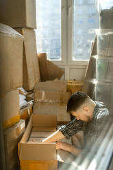 Mann packt Kartons für Umzug - ANAF01311