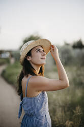 Woman wearing hat and day dreaming - LHPF01546