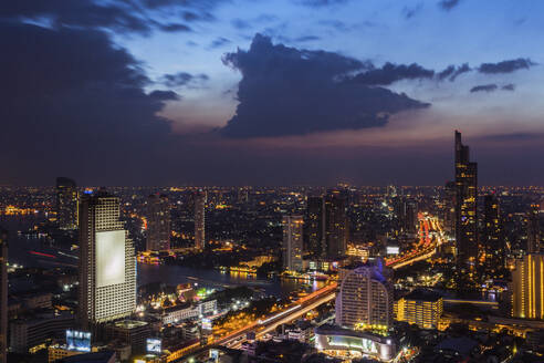 Thailand, Bangkok, Clouds over city downtown at dusk - IKF00406