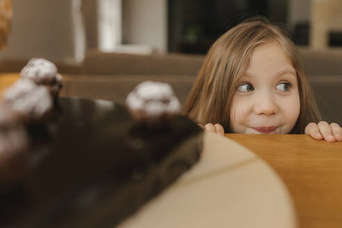 Smiling blond girl with fresh cake on table - VIVF00853