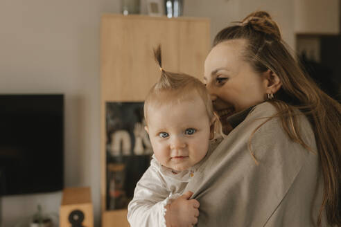 Happy woman carrying cute daughter at home - VIVF00873