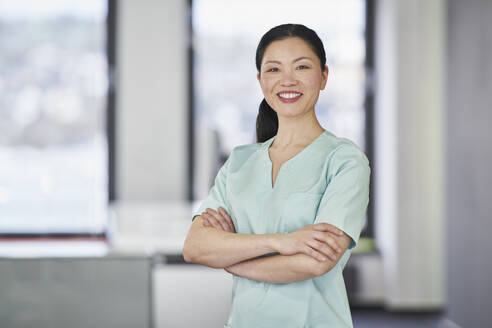 Portrait of smiling nurse in scrubs - RORF03457