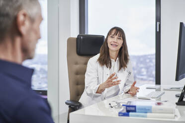 Female doctor talking to senior patient in medical practice - RORF03478