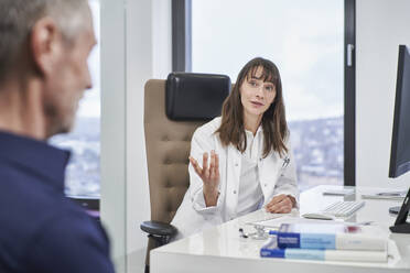 Female doctor talking to senior patient in medical practice - RORF03479