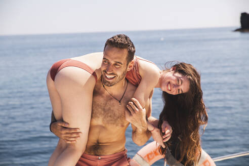 Smiling man having fun with girlfriend on boat at vacation - PCLF00460