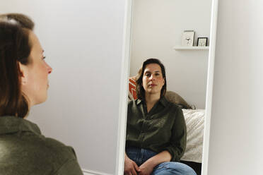 Freelancer sitting in front of mirror at home - ASGF03571