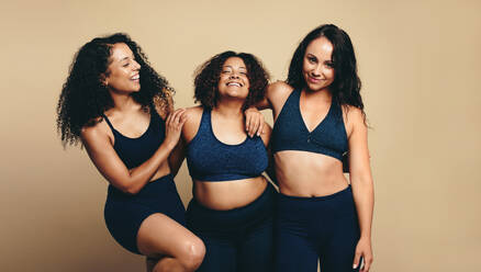 Group of five women in sportswear with fitness accessories standing  together. Diverse females posing together in studio stock photo (255565) -  YouWorkForThem