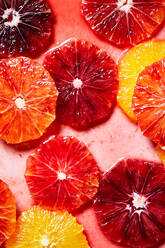 Top view Hintergrund der bunten frischen saftigen Grapefruit und Orangenscheiben in Wasser für Aufnahmen und Cocktails Vorbereitung platziert - ADSF43869