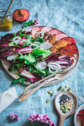 From above of delicious healthy grilled Plum and Endive salad with assorted vegetables and spices placed on table - ADSF44026