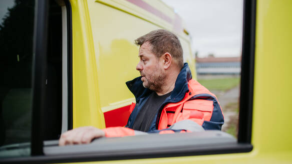 Rescuer getting in to ambulance car, preparing for the rescue operation. - HPIF09411