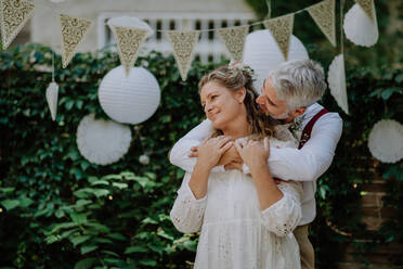 Close-up of bride and groom dancing at their outdoor wedding. - HPIF09510