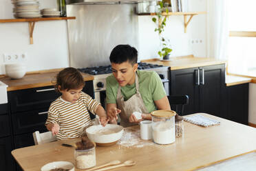 Mother and son preparing food in kitchen at home - EBSF03300