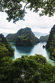 Green mountains amidst sea at Coron Island in Philippines - PNAF05267