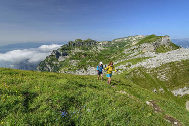 Italy, Province of Belluno, Pair of hikers following Alta Via Dolomiti Bellunesi trail - ANSF00333