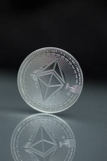 Close-up of silver colored Ethereum coin - MMAF01451