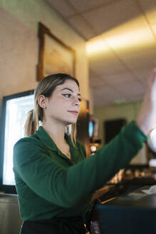 Young waitress working at bar - EGAF02604