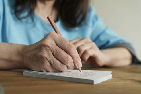 Doctor writing prescription with pen at medical practice - OSF01553