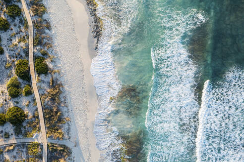 Spain, Balearic Islands, Formentera, Drone view of boardwalk stretching along sandy beach - MMAF01466