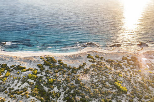 Spain, Balearic Islands, Formentera, Drone view of Mediterranean beach at sunset - MMAF01484