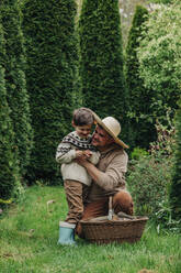 Father and son having fun in garden - VSNF00851