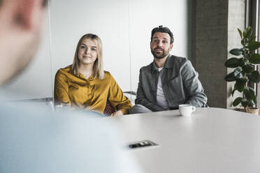 Business colleagues discussing in meeting at office - UUF28549