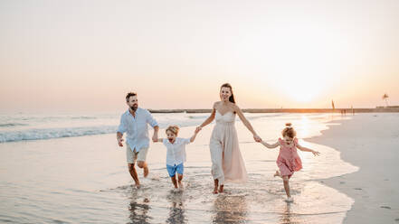Happy family with little kids enjoying time at the sea in exotic country. - HPIF09623
