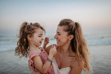 Mother enjoying together time with her daughter at the sea. - HPIF09638