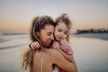 Mother enjoying together time with her daughter at the sea. - HPIF09639