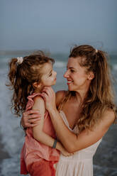 Mother enjoying together time with her daughter at the sea. - HPIF09649