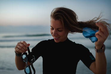 Young woman preparing for diving on the beach. - HPIF09658