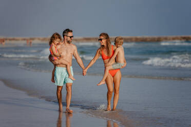Happy family with little kids enjoying time at the sea in exotic country. - HPIF09691