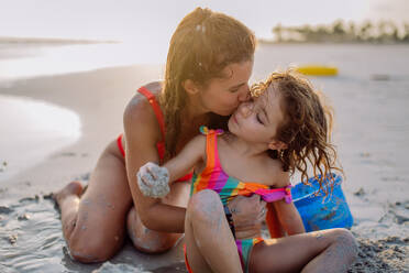 Mother with her little daughter enjoying time at the sea. - HPIF09712