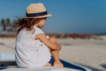 Rear view of little girl looking at the ocean. - HPIF09779