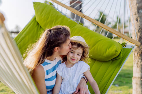 Mother with her daughter enjoying their holiday in exotic country, lying in hammock. - HPIF09784