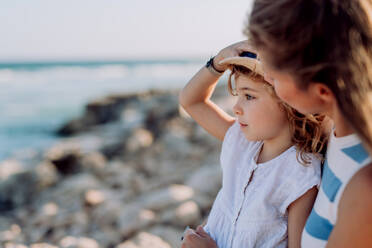 Mother enjoying together time with her daughter at the sea. - HPIF09787