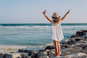 Rear view of little girl looking at the ocean. - HPIF09788