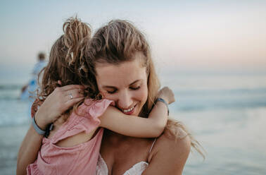 Mother enjoying together time with her daughter at the sea. - HPIF09809