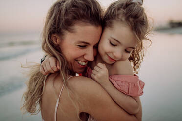 Mother enjoying together time with her daughter at the sea. - HPIF09810