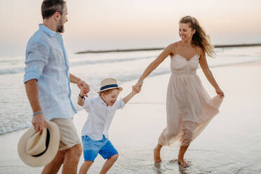 Happy family with little kids enjoying time at the sea in exotic country. - HPIF09813