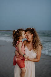 Mother enjoying together time with her daughter at the sea. - HPIF09816