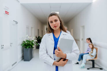 Portrait of young woman doctor at a hospital corridor. - HPIF09929