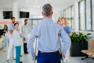 Medical staff clapping to patient who recovered from a serious accident. - HPIF10007