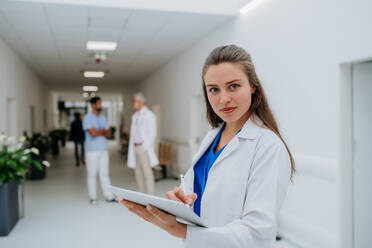 Portrait of young woman doctor at a hospital corridor. - HPIF10052