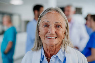 Portrait of elderly doctor at a hospital corridor. - HPIF10061