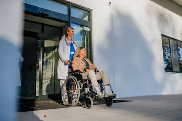 Young woman doctor taking care of senior woman at a wheelchair. - HPIF10085