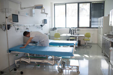 Young man with down syndome working in a hospital as helper, cleaner. Concpet of integration people with disability into society. - HPIF10158