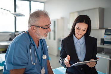 Young pharmaceutic seller explaining something to doctor in a hospital. - HPIF10189